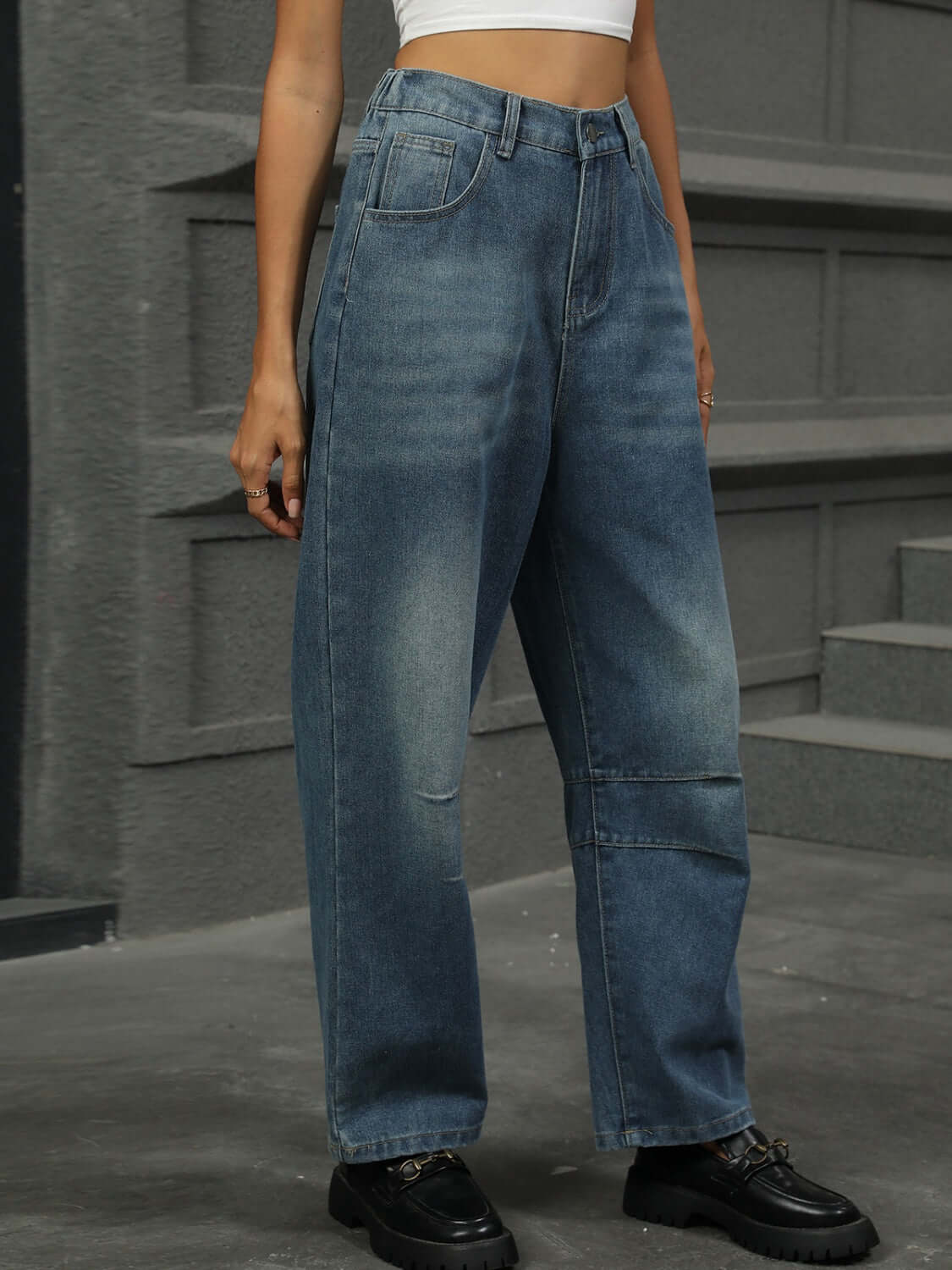 Woman wearing Half Elastic Waist Straight Leg Jeans showcasing a comfortable fit and style against a grey background.