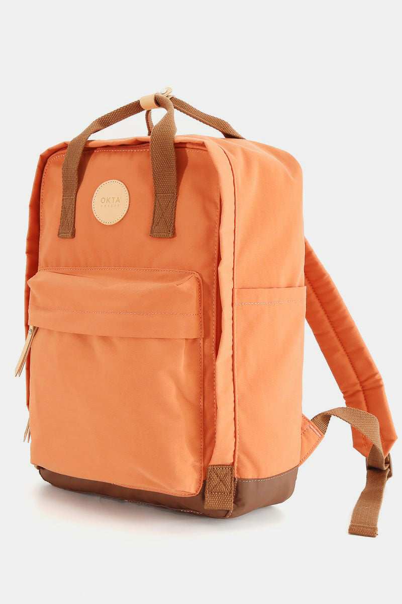 Orange waterproof canvas backpack with side pockets and durable straps. Perfect for stylish organizing and carrying essentials.