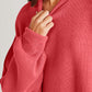 Red side slit round neck long sleeve sweater with moderate stretch worn by a model, made of 95% cotton and 5% polyester.