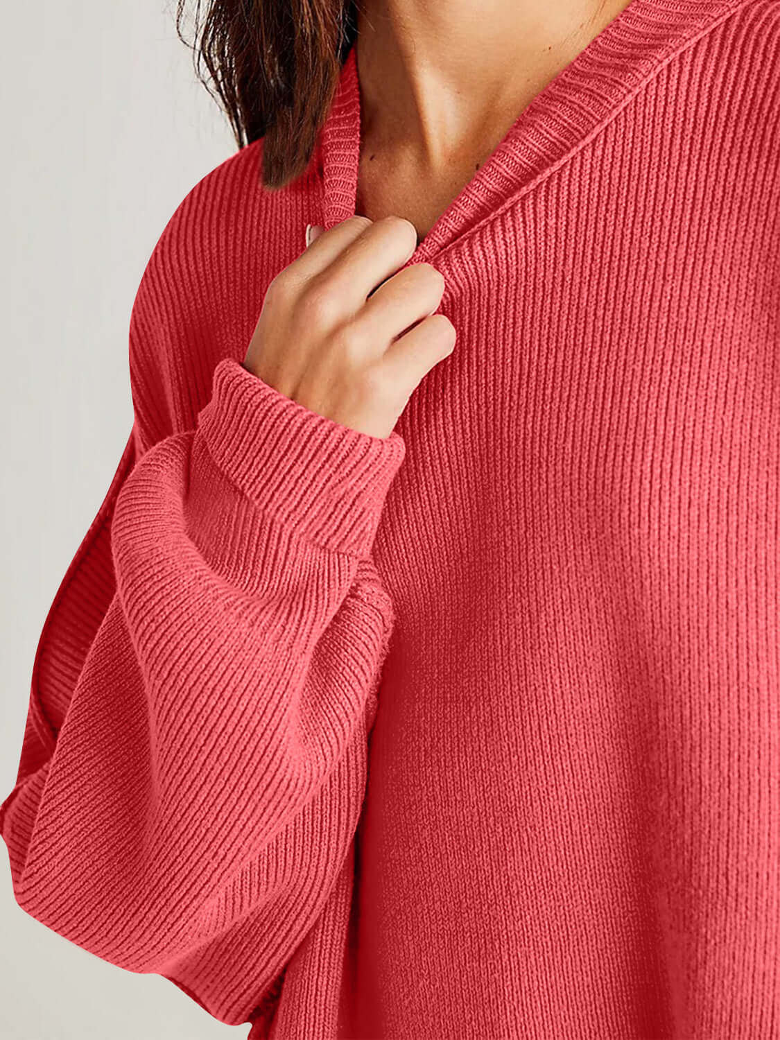 Red side slit round neck long sleeve sweater with moderate stretch worn by a model, made of 95% cotton and 5% polyester.