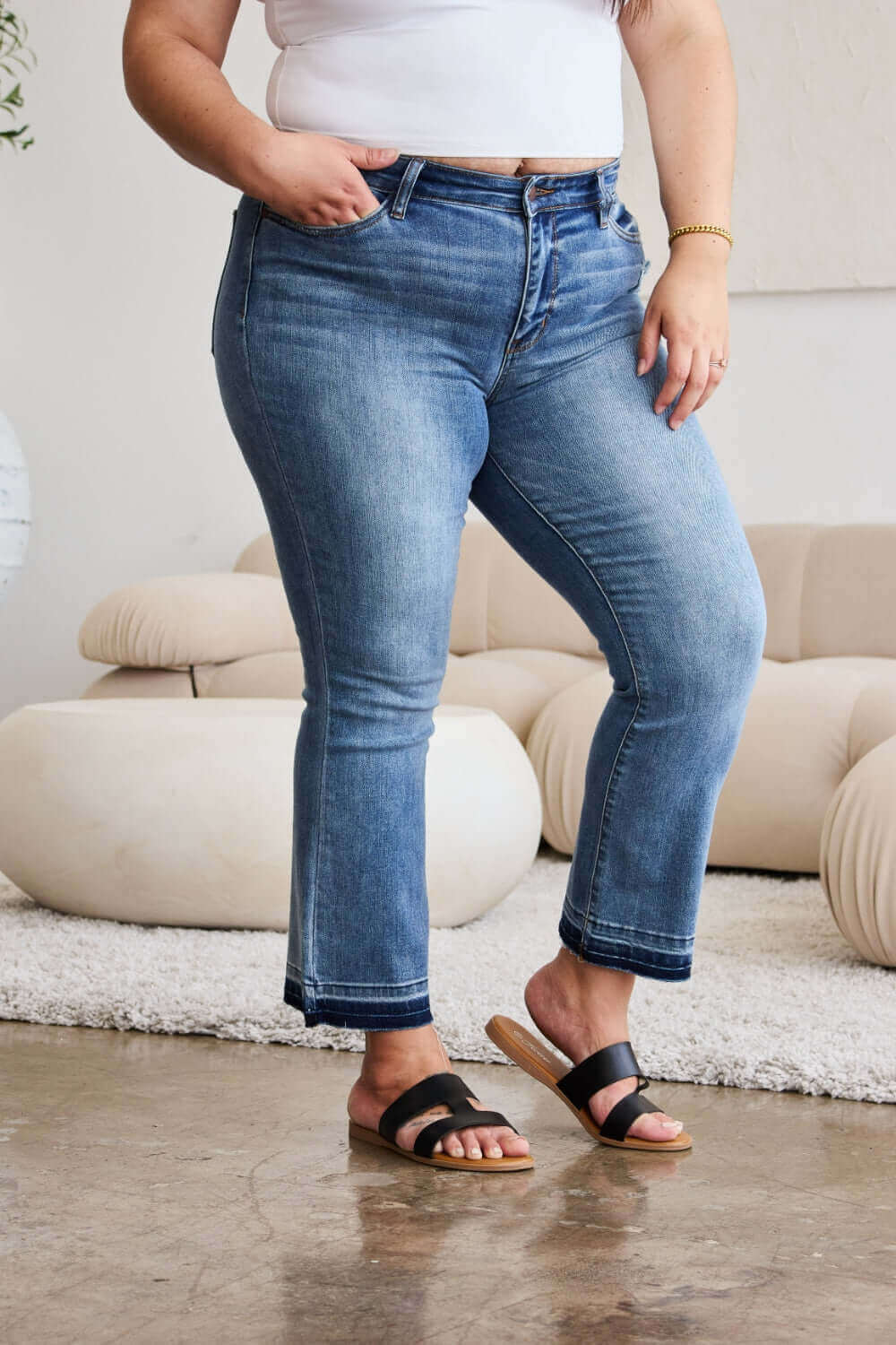 Release hem cropped bootcut Judy Blue Jeans styled with sandals for a fashionable look.