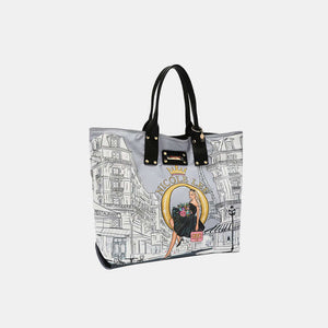 Nicole Lee USA reversible handbag with stylish print design and black handles, perfect for versatile fashion statements.