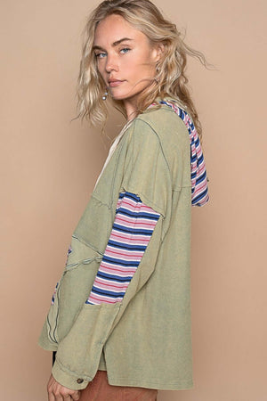 Woman wearing POL Star Patchwork Hoodie with raw edges and colorful striped hood, showcasing relaxed fit and chic design.