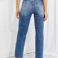 Back view of Emily High Rise Relaxed Jeans with ripped knees, featuring a cropped length, moderate stretch, and casual distressed style. Risen Jeans.