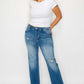 Model showcasing bytos Raw Hem Distressed Mid Rise Straight Jeans with a casual white tee and stylish sandals.