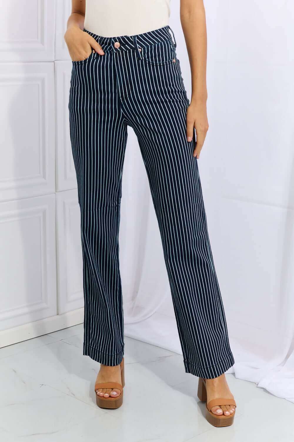 Woman wearing Cassidy high waisted tummy control striped straight Judy Blue jeans for a flattering fit