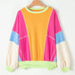 Bella Road Color Block Round Neck Long Sleeve Top with pink, orange, blue, and white blocks hanging on a wooden hanger