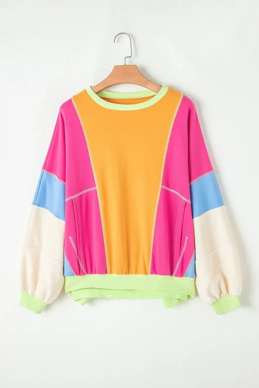 Bella Road Color Block Round Neck Long Sleeve Top with pink, orange, blue, and white blocks hanging on a wooden hanger