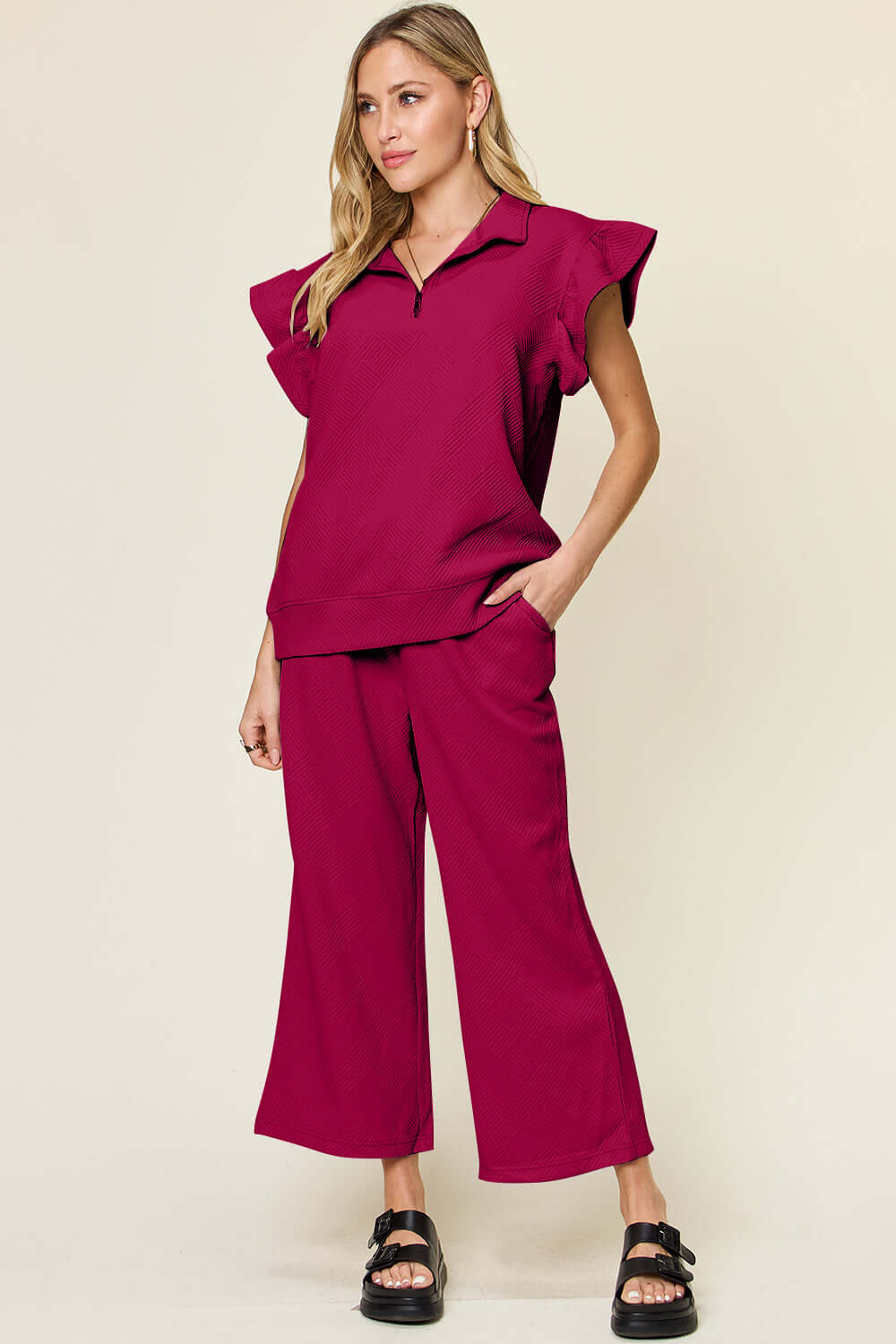 Woman wearing a Texture Ruffle Short Sleeve Top and Drawstring Wide Leg Pants Set in dark pink; features drawstring, pockets, and short sleeves.