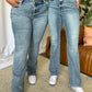 Women wearing Judy Blue medium rise bootcut jeans showcasing a flattering fit and comfortable style for everyday wear.