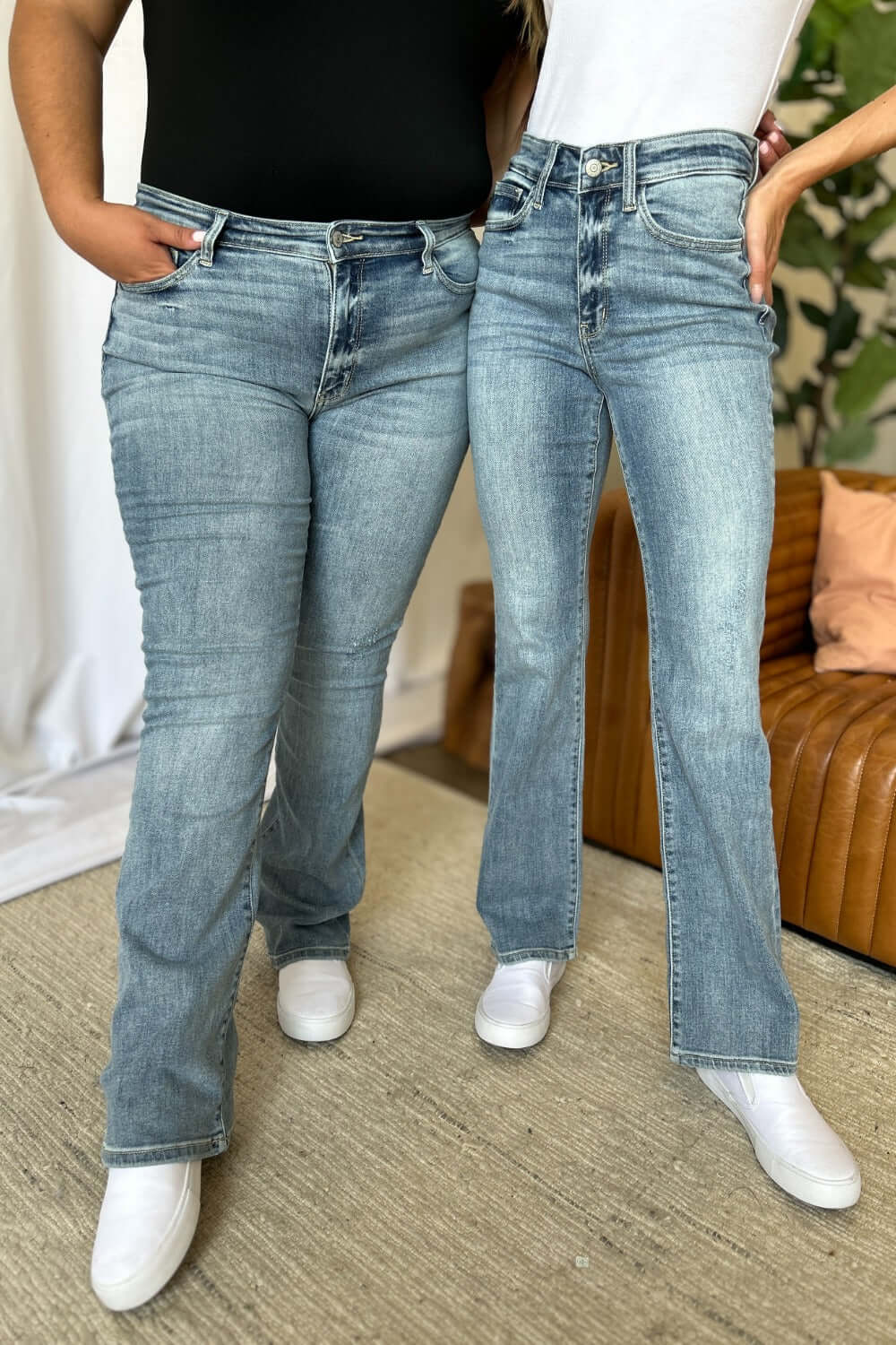 Women wearing Judy Blue medium rise bootcut jeans showcasing a flattering fit and comfortable style for everyday wear.