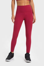 Millennia highly stretchy wide waistband yoga leggings in berry color, perfect for comfort and flexibility during workouts.