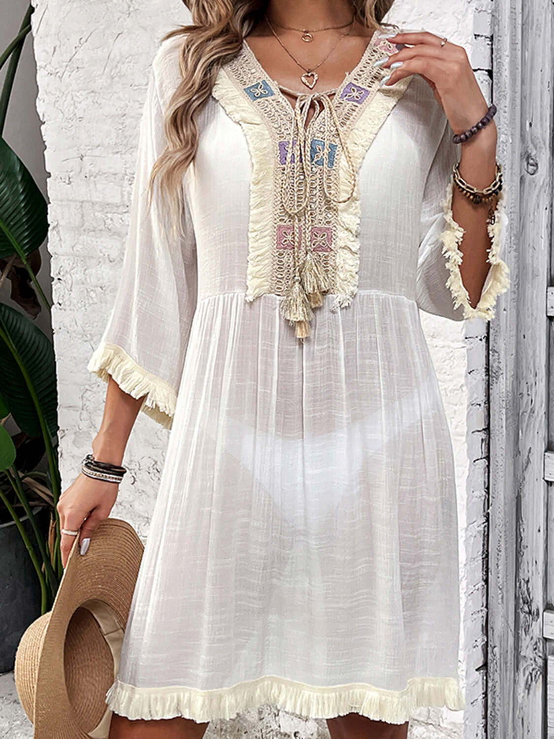 Fringe Tie Neck Three-Quarter Sleeve Cover Up in sheer white fabric made of cotton and polyester, featuring a boho style with intricate fringe details.