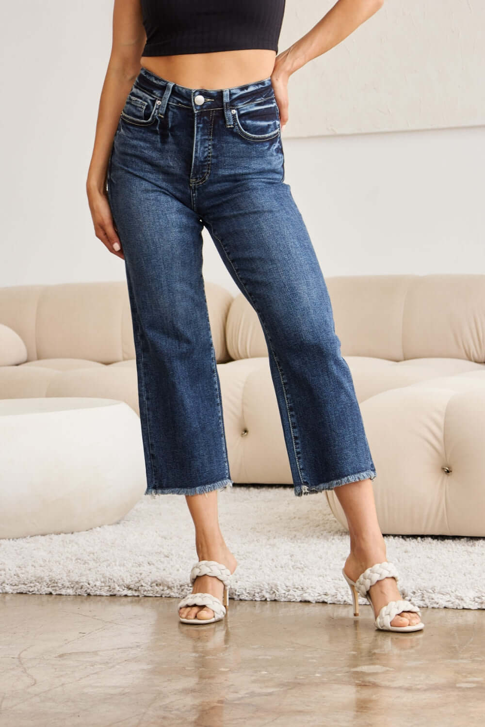 Woman wearing Tummy Control High Waist Raw Hem Distressed Jeans with tummy control technology and trendy raw hem. RFM Jeans.