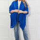 JUSTIN TAYLOR Pom-Pom Asymmetrical Poncho Cardigan in Blue at Bella Road