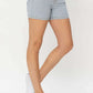 Woman wearing color block denim shorts by Judy Blue Jeans, featuring a fun and trendy summer style.