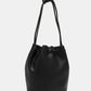 Nicole Lee USA Amy Studded Bucket Bag in black vegan leather with drawstring closure and metal feet for durability.