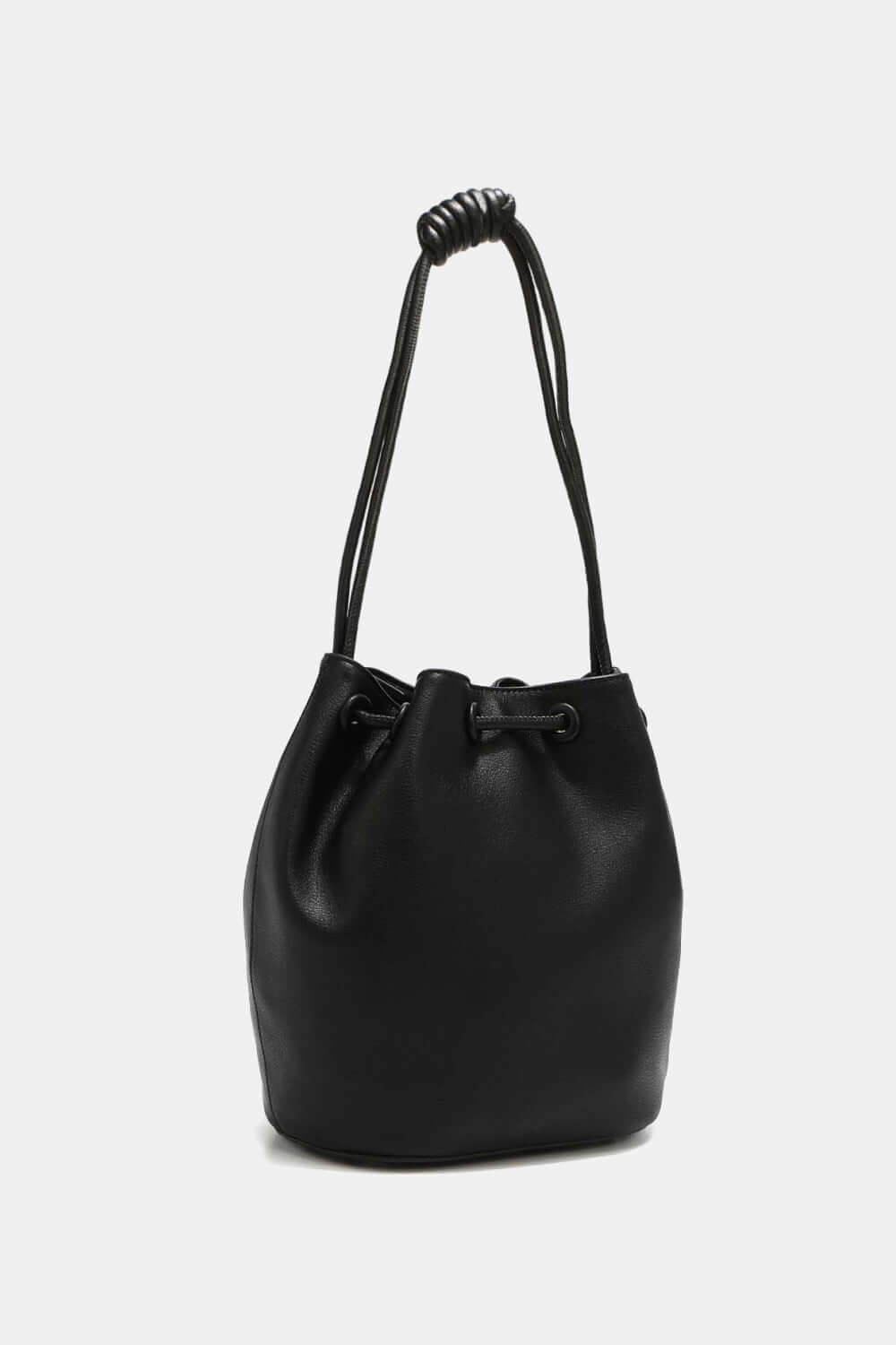 Nicole Lee USA Amy Studded Bucket Bag in black vegan leather with drawstring closure and metal feet for durability.