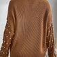 Bella Road sweater with pearl detail on sleeves, round neck, and long sleeves in brown seen from the back. Perfect for elevating style.