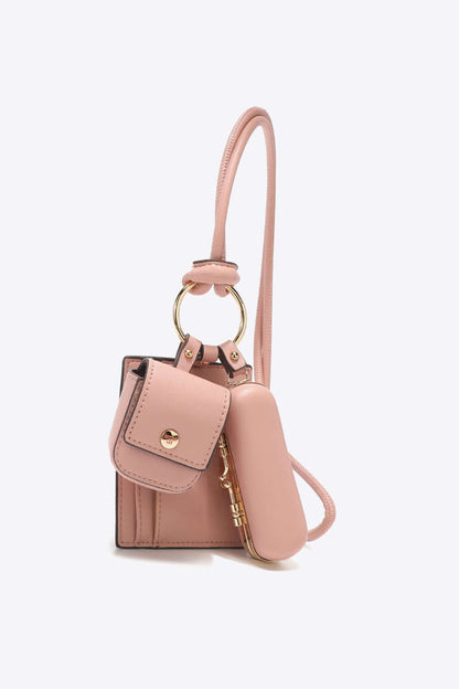 Nicole Lee USA Vegan Leather 3-Piece Lanyard Set featuring a pink AirPods case and small bag with gold accents