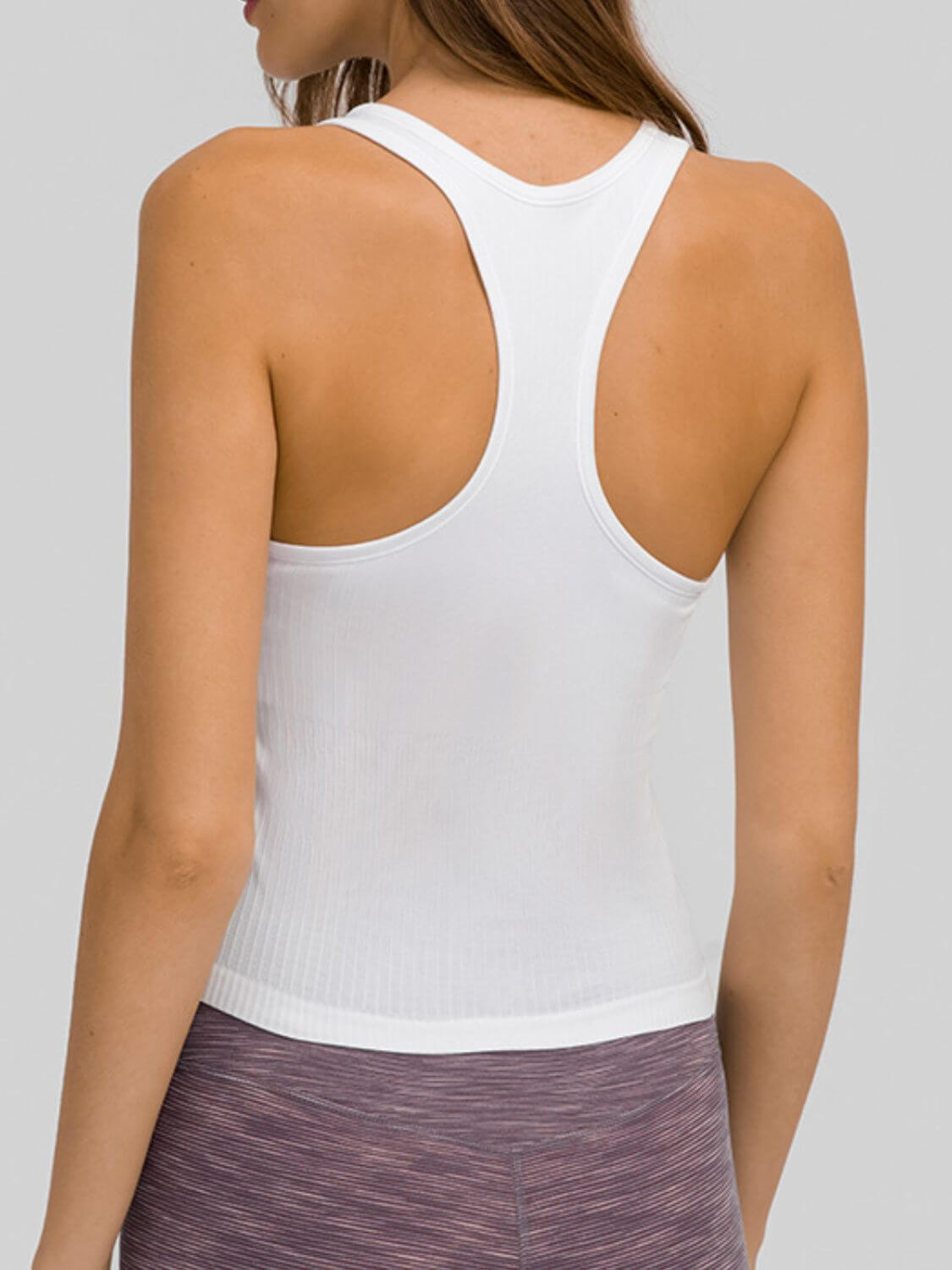 Back view of the Millennia Round Neck Racerback Active Tank in white, showcasing its stylish racerback design and comfortable fit.