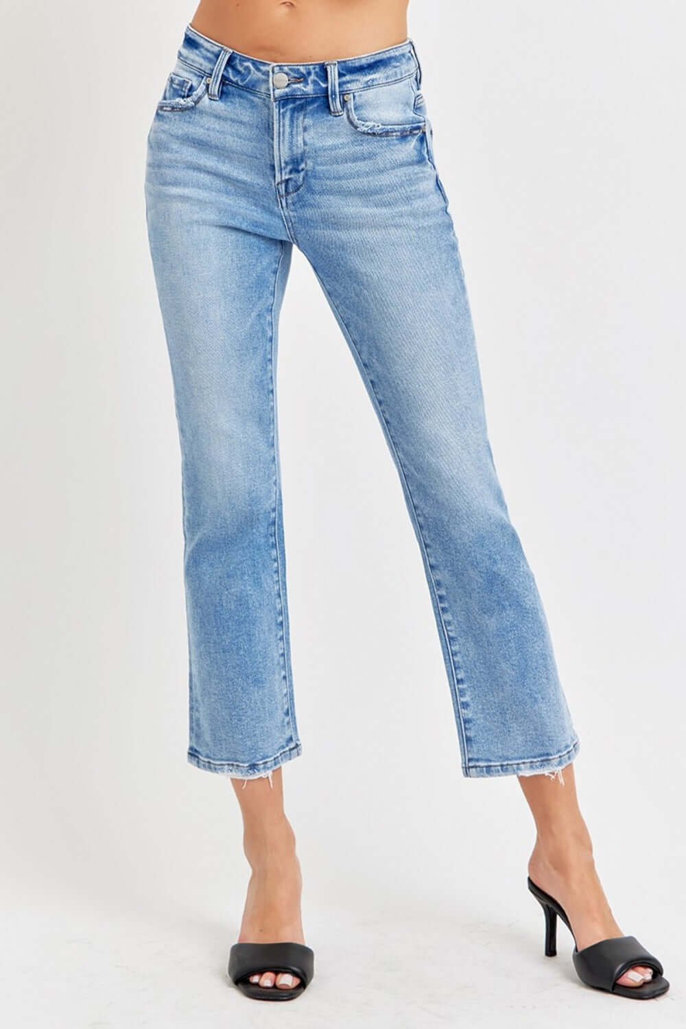 Risen low rise crop slim straight jeans with raw hem and pockets, showcasing a versatile and flattering fit for modern style.