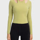 Stylish long sleeve sporty top in green with unique cutouts, perfect for workouts and casual wear.