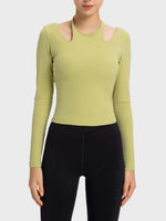 Stylish long sleeve sporty top in green with unique cutouts, perfect for workouts and casual wear.