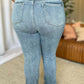 Woman wearing Judy Blue full size medium rise bootcut jeans, showcasing the flattering fit and slight flare design for a balanced silhouette.