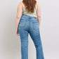 Back view of a model wearing Judy Blue high waist bootcut jeans, showcasing their vintage wash and flattering fit.