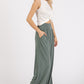 Woman wearing Mittoshop stretch banded waist wide leg pants with pockets, showcasing stylish and comfortable fashion.