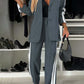 Stylish model in gray denim two-piece set with contrast lapel collar, featuring side stripes and chic accessories.