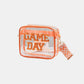 Transparent crossbody bag with "Game Day" patch, orange trim, and zigzag strap, perfect for stadium security checks.