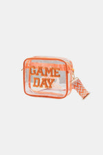 Transparent crossbody bag with "Game Day" patch, orange trim, and zigzag strap, perfect for stadium security checks.