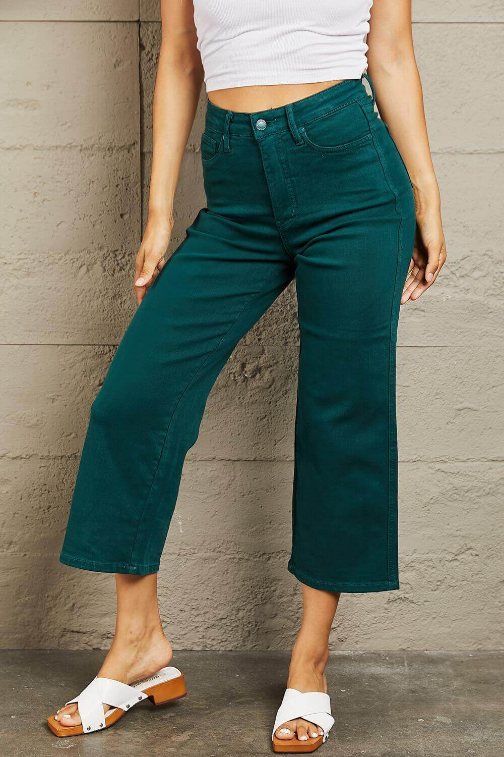 Woman wearing Hailey full-size tummy control high-waisted cropped wide-leg Judy Blue jeans.