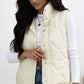 Woman wearing Bella Road ivory snap down texture vest coat with pockets, perfect for fall and winter fashion.