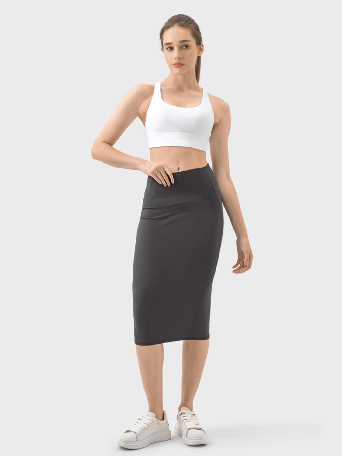 Model showcasing the Millennia Slit Wrap Active Skirt paired with a stylish crop top, ideal for active wear and casual outings.