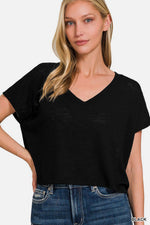 Woman wearing a black V-Neck Short Sleeve Crop T-Shirt paired with high-waisted jeans.