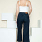 Woman wearing Judy Blue crop wide leg jeans with side seam braid detail from the back, styled with a white top.