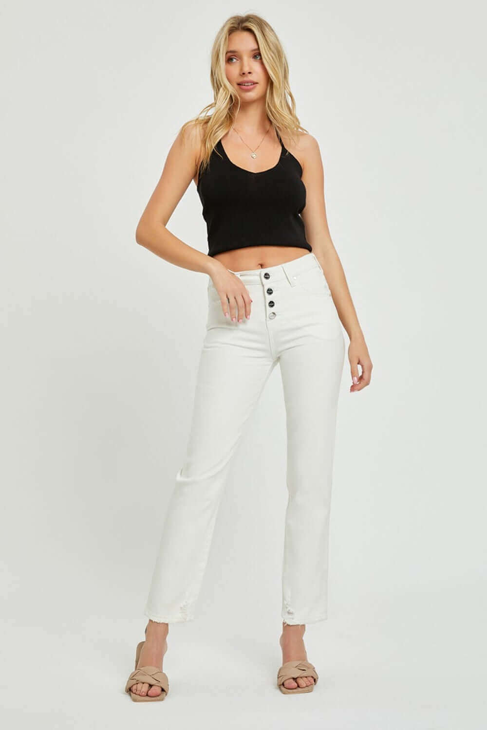 Woman in mid-rise tummy control straight jeans by Risen Jeans, paired with a black crop top and sandals, showcasing a casual chic look.