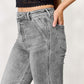 Woman wearing high waist slim flare jeans paired with a black cropped top, showcasing stylish and flattering denim fashion.