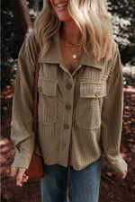 Woman wearing textured pocketed collared neck long sleeve shacket in an outdoor setting.