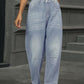 Woman wearing Half Elastic Waist Straight Leg Jeans in light blue, showcasing comfortable and stylish design with a flattering fit.