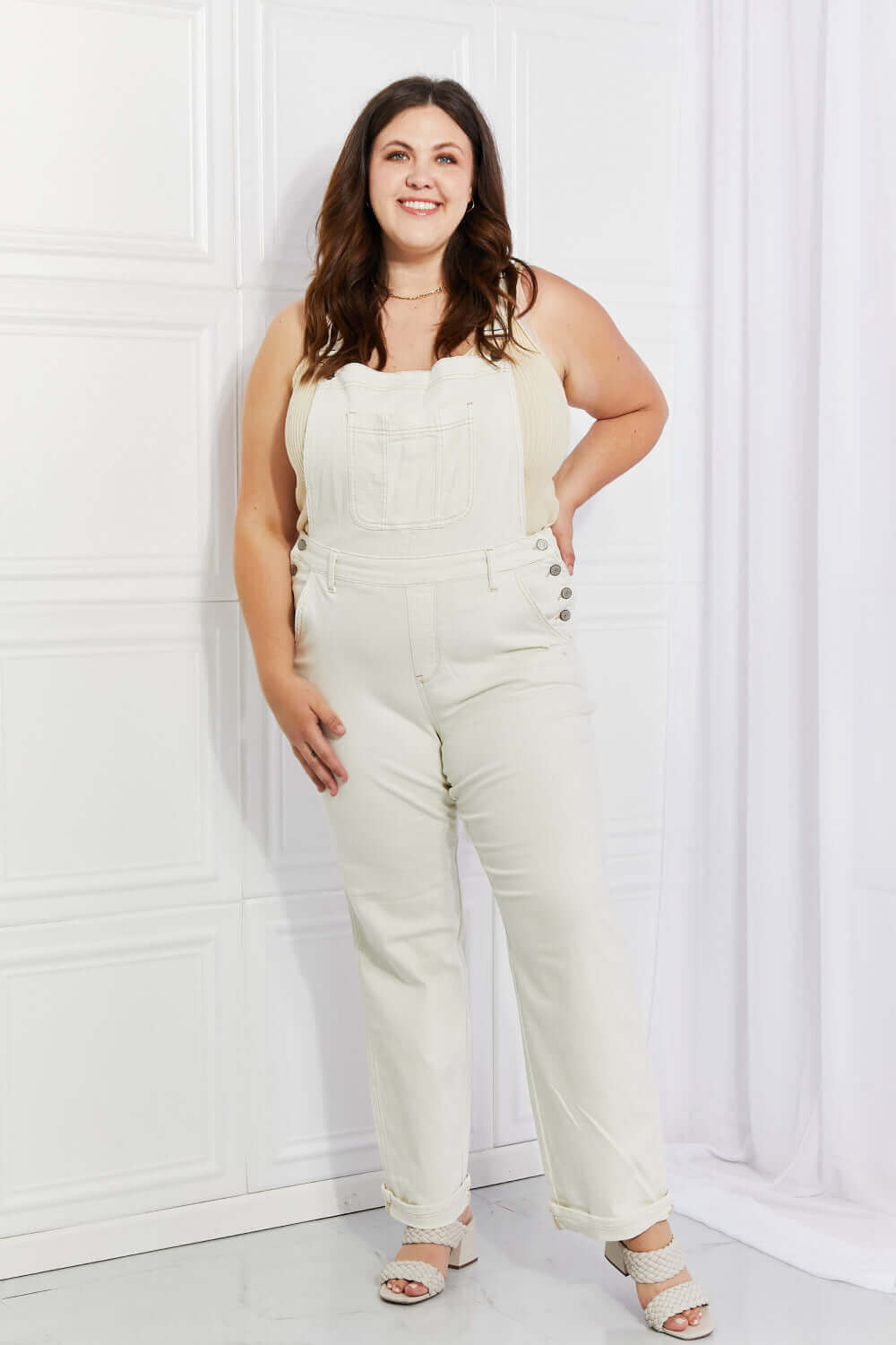 Woman wearing Taylor High Waist Overalls | Full Size by Judy Blue Jeans in solid color, casual style with pockets and long length