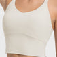 Crisscross round neck active tank in light beige, showcasing breathable fabric and modern design for active wear.