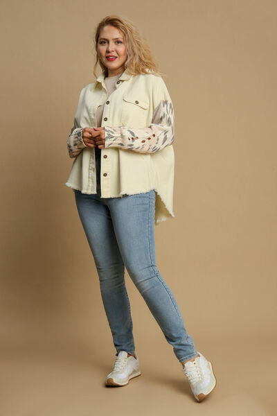 Stylish plus-size model in Umgee distressed button-up jacket with raw hem, paired with light jeans and sneakers.