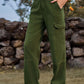 Woman wearing Bella Road High Waist Cargo Straight Jeans in green with multiple pockets, standing outdoors.