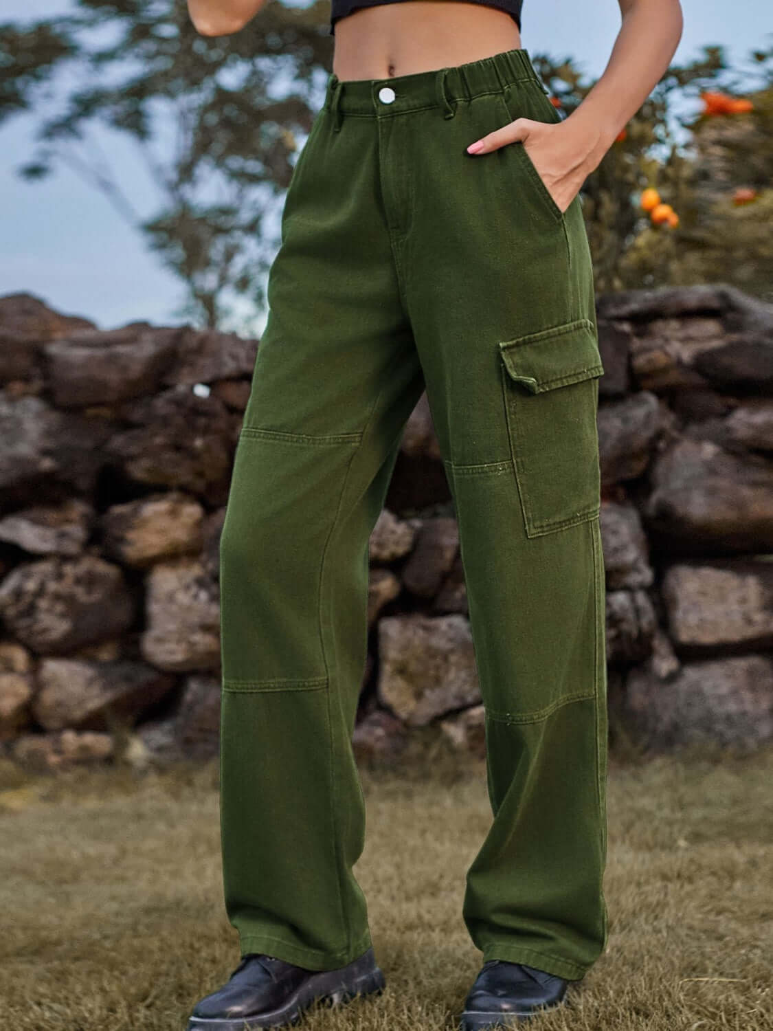 Woman wearing Bella Road High Waist Cargo Straight Jeans in green with multiple pockets, standing outdoors.