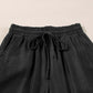 Close-up of Bella Road Drawstring Wide Leg Jeans in black showcasing the trendy drawstring waist and soft fabric.