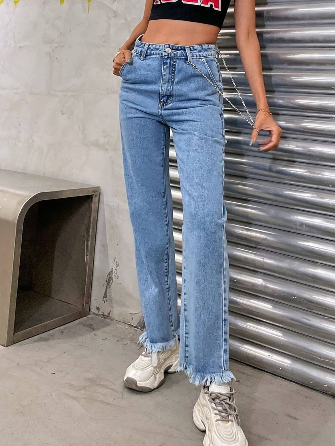 Stylish raw hem jeans with pockets, no stretch, light blue denim, perfect casual wear. Model wearing jeans with sneakers.